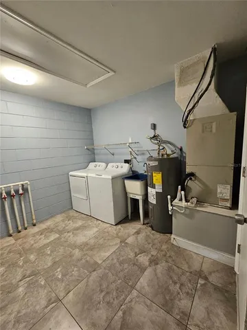 a utility room with a sink dryer and washer