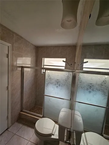 a bathroom with a toilet and a shower