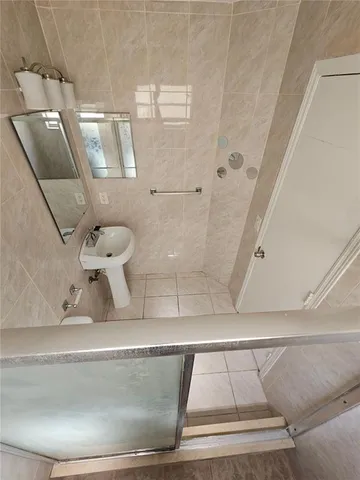 a bathroom with a toilet and a mirror