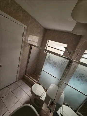 a white toilet sitting next to a bathroom sink