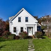 a front view of a house with a garden