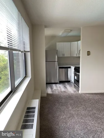 a kitchen with stainless steel appliances a refrigerator and a gate