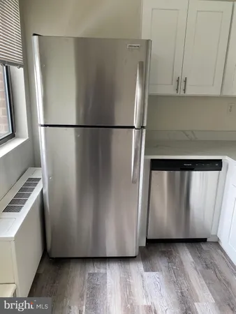 a stove top oven sitting inside of a kitchen