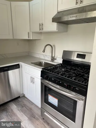 a kitchen with granite countertop a stove and a refrigerator