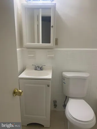 a white toilet and tub sitting next to a bathroom sink