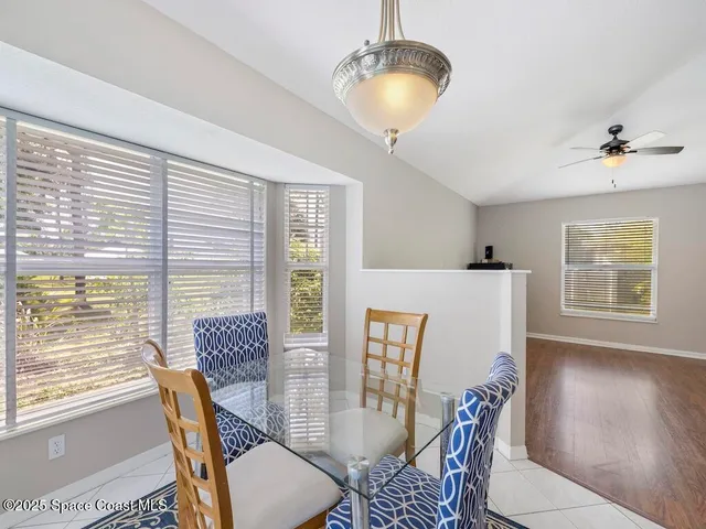 a view of a livingroom with wooden floor and a ceiling fan