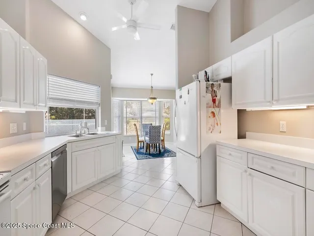 a view of a livingroom with wooden floor and a ceiling fan