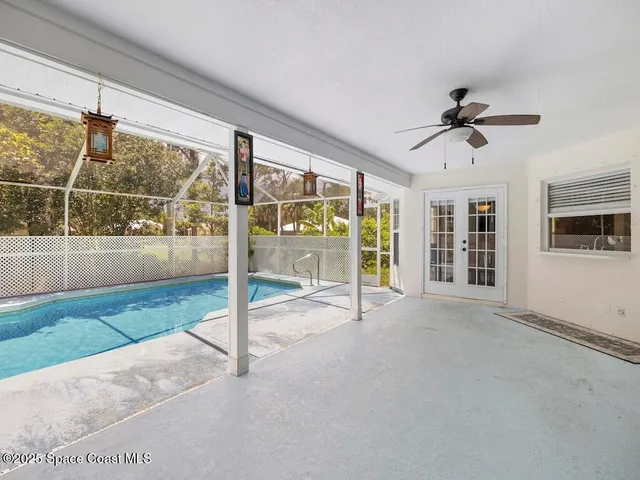 a view of a patio with table and chairs under an umbrella