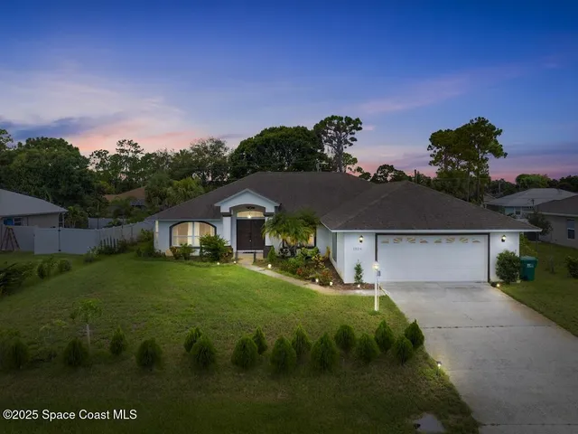 an aerial view of residential houses with outdoor space and garden