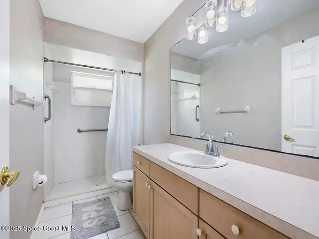 a view of a room with wooden floor and a ceiling fan