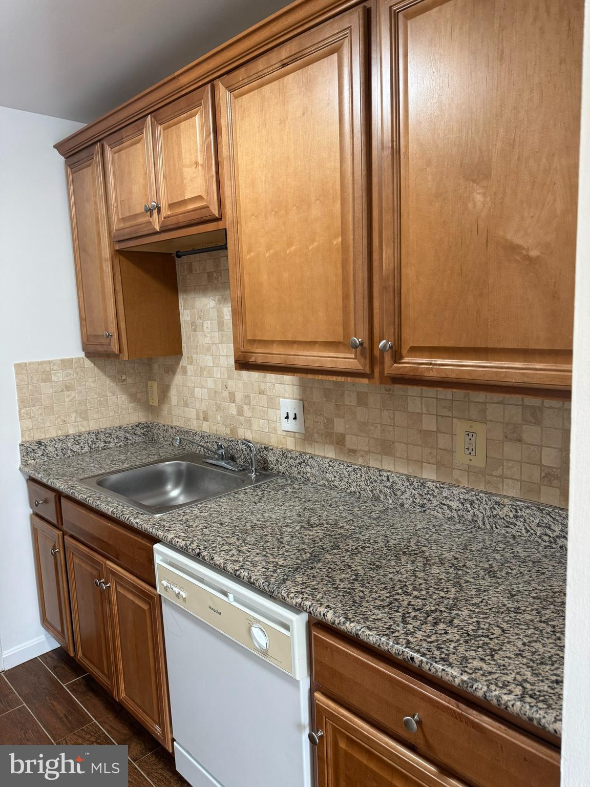7597 Gales Court, Unit 7A 202 Manassas, VA 20109 - Photo 3 of 16 a kitchen with granite countertop cabinets washer and dryer