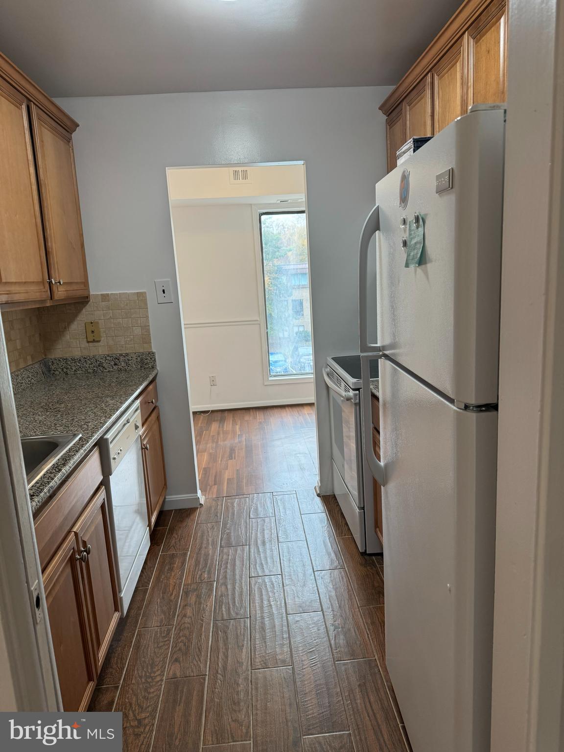7597 Gales Court, Unit 7A 202 Manassas, VA 20109 - Photo 4 of 16 a kitchen with wooden floors and appliances