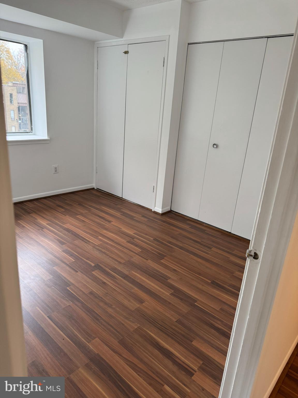 7597 Gales Court, Unit 7A 202 Manassas, VA 20109 - Photo 7 of 16 a view of an empty room with wooden floor and closet