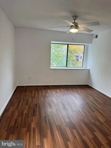 a view of room with window and wooden floor