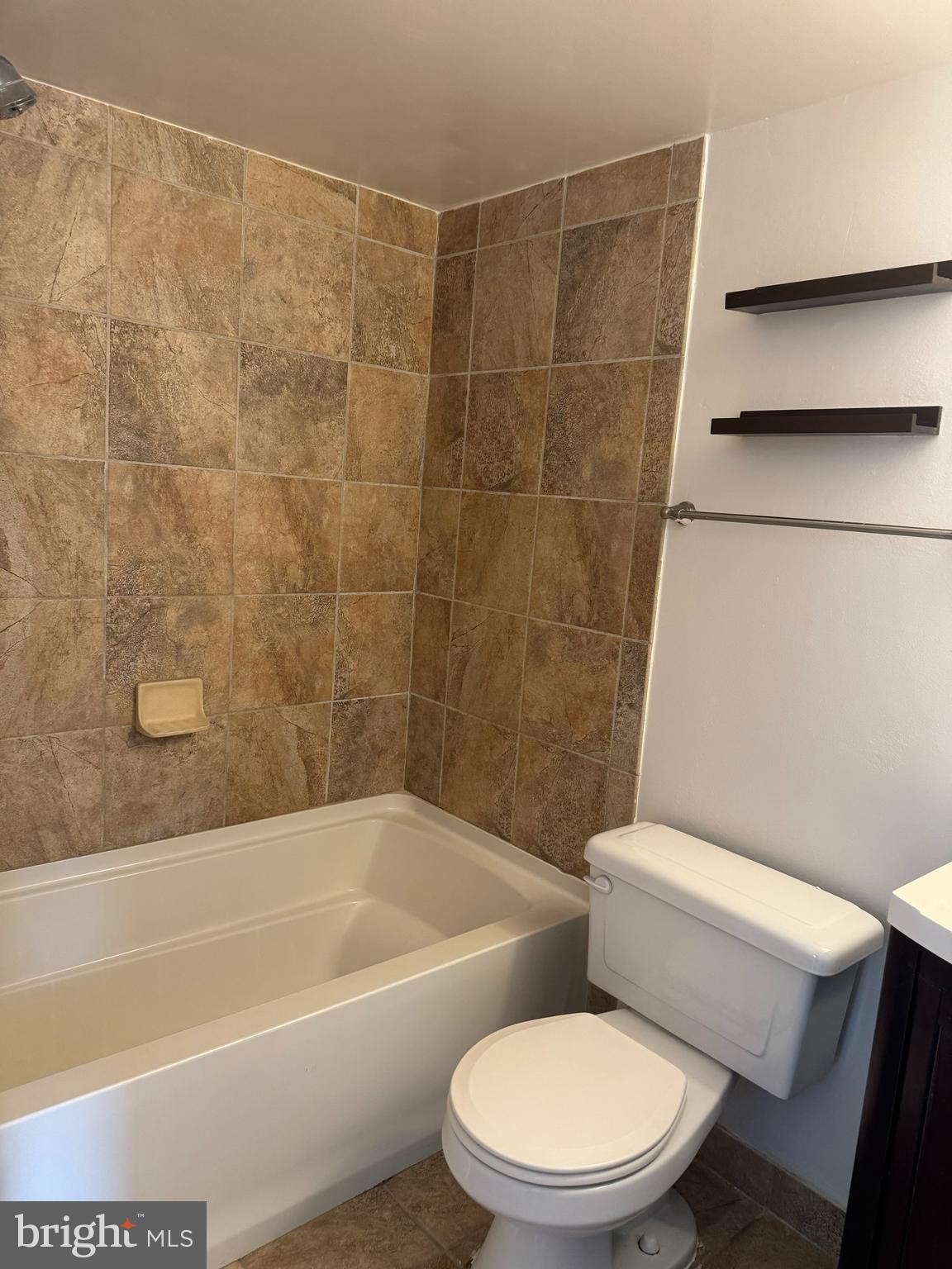 7597 Gales Court, Unit 7A 202 Manassas, VA 20109 - Photo 9 of 16 a white toilet and tub sitting next to a bathroom sink