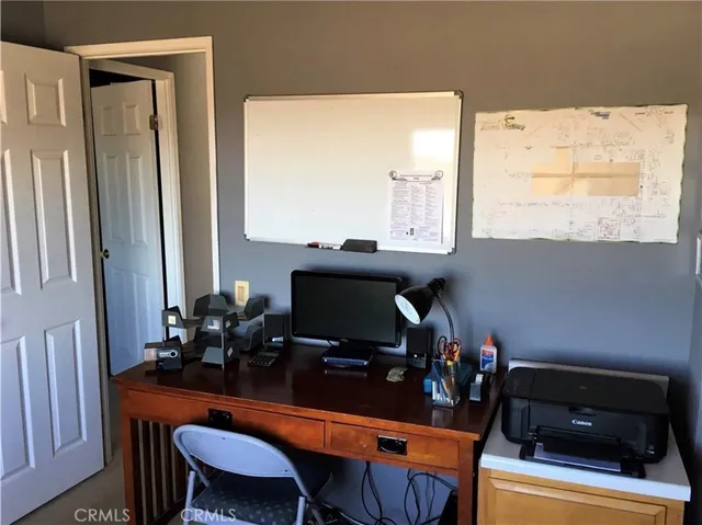 a room with a table chairs and a computer