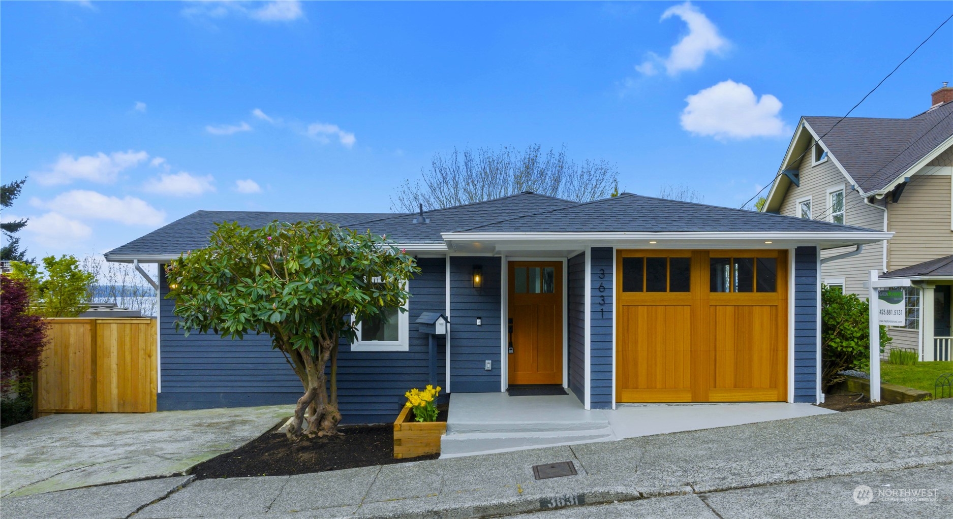 3631 59th Avenue Southwest Seattle, WA 98116 - Photo 1 of 40 a front view of a house with a garden