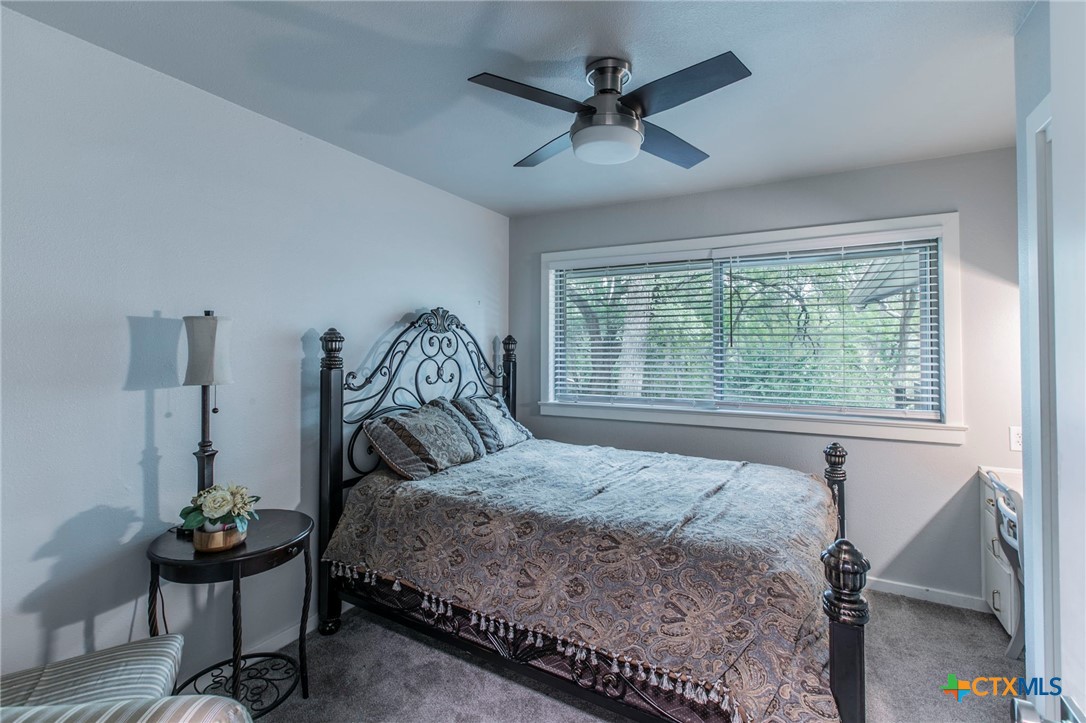 2518 Marlandwood Road Temple, TX 76502 - Photo 30 of 48 a bedroom with a bed a window and a chandelier