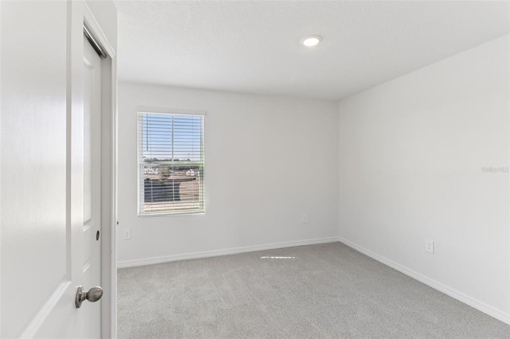 721 Spartina Street Lady Lake, FL 32159 - Photo 16 of 32 a view of an empty room with a window