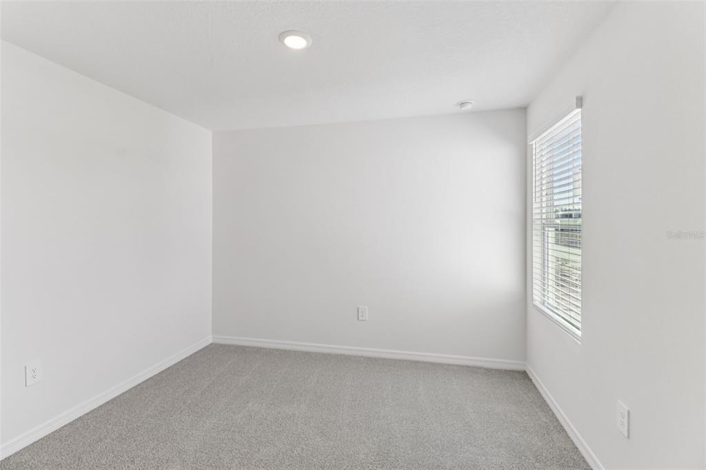 721 Spartina Street Lady Lake, FL 32159 - Photo 18 of 32 a view of an empty room and a window