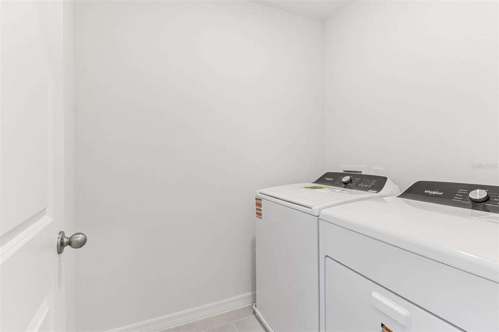 721 Spartina Street Lady Lake, FL 32159 - Photo 23 of 32 a utility room with dryer and washer