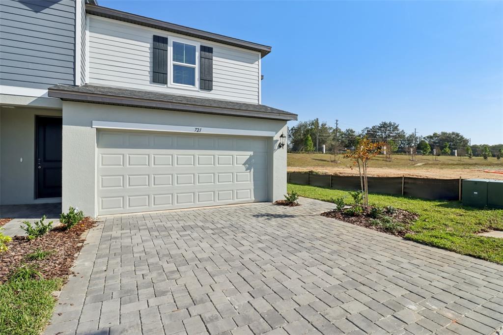 721 Spartina Street Lady Lake, FL 32159 - Photo 3 of 32 a front view of a house with a yard and garage