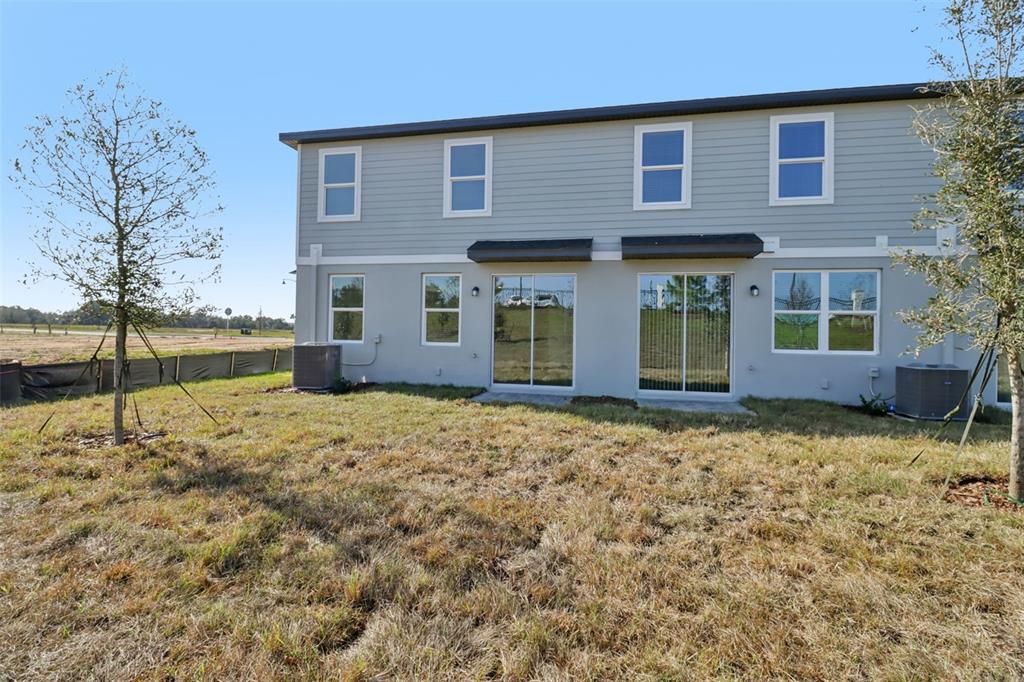 721 Spartina Street Lady Lake, FL 32159 - Photo 31 of 32 a view of a house with a yard
