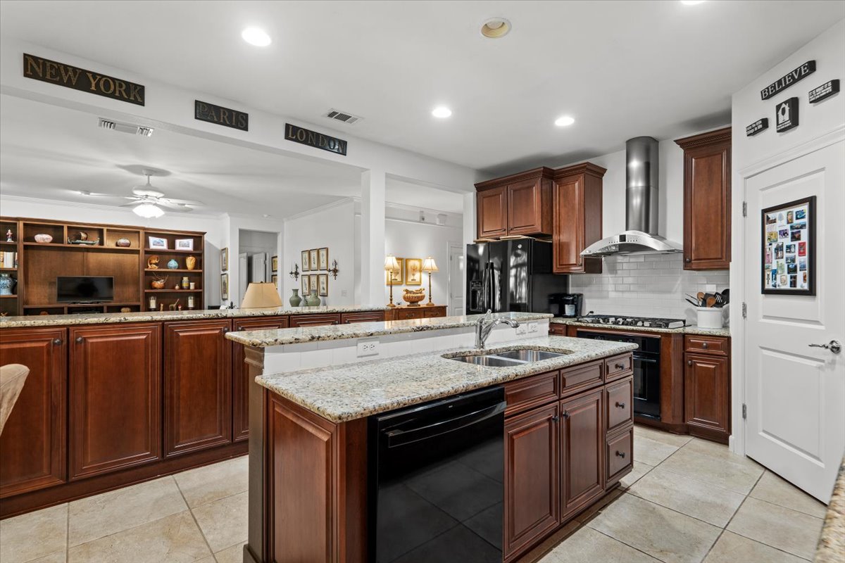 503 Breezeway Lane Georgetown, TX 78633 - Photo 8 of 38 Spacious kitchen with granite countertops, abundant cabinetry, and a functional layout that opens to the breakfast area and great room. Large island with sink provides additional prep space and seating.
