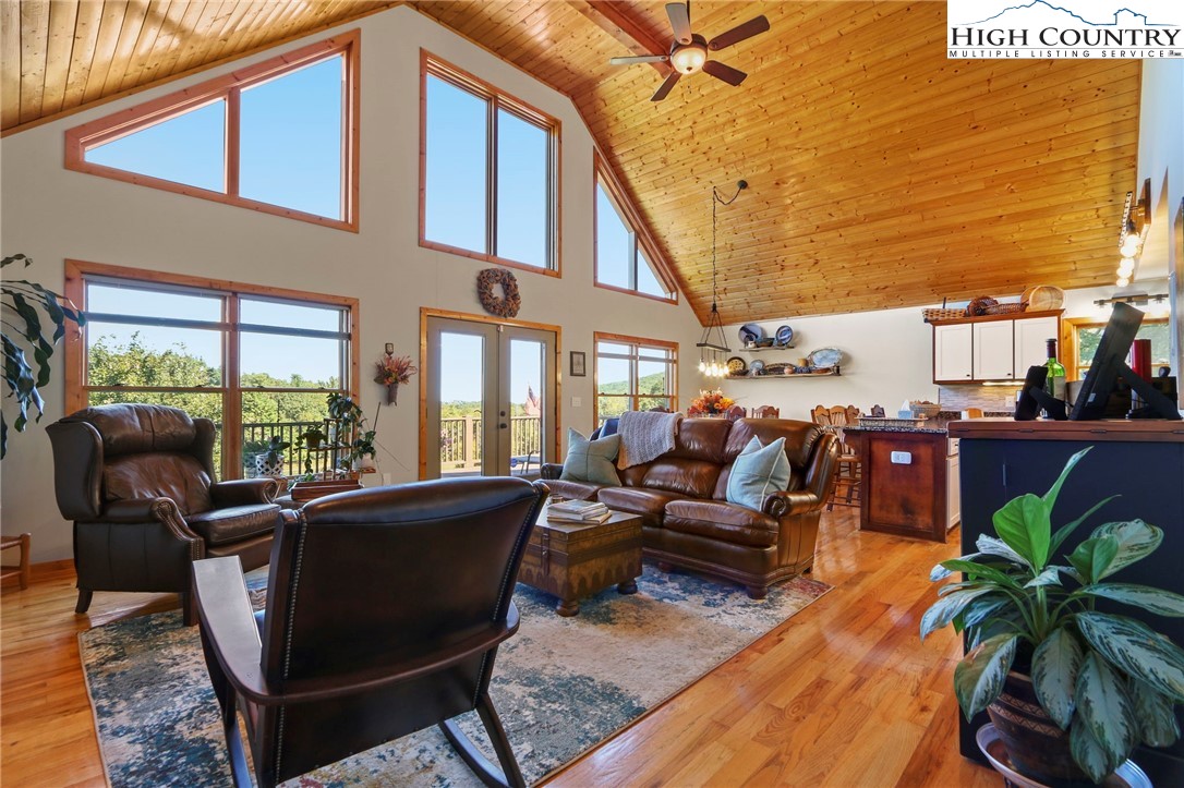 195 Omerta Lane Boone, NC 28607 - Photo 17 of 50 a view of a patio with couches table and chairs and potted plants