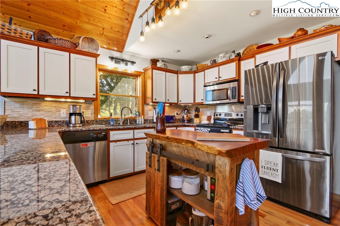 195 Omerta Lane Boone, NC 28607 - Photo 24 of 50 a kitchen with stainless steel appliances granite countertop a stove a sink and a refrigerator