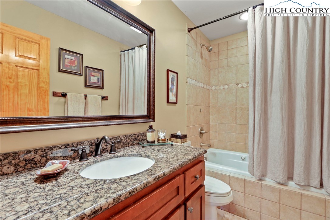 195 Omerta Lane Boone, NC 28607 - Photo 32 of 50 a bathroom with a granite countertop sink and a mirror