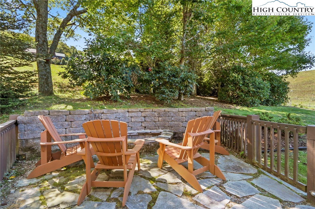 195 Omerta Lane Boone, NC 28607 - Photo 44 of 50 a view of a patio with table and chairs and wooden fence
