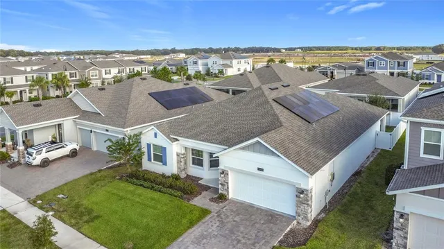 an aerial view of a house with a yard lake view and mountain view