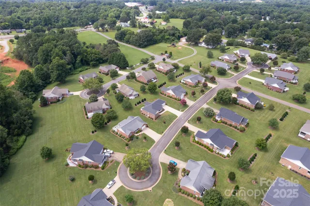 an aerial view of residential house with outdoor space and swimming pool