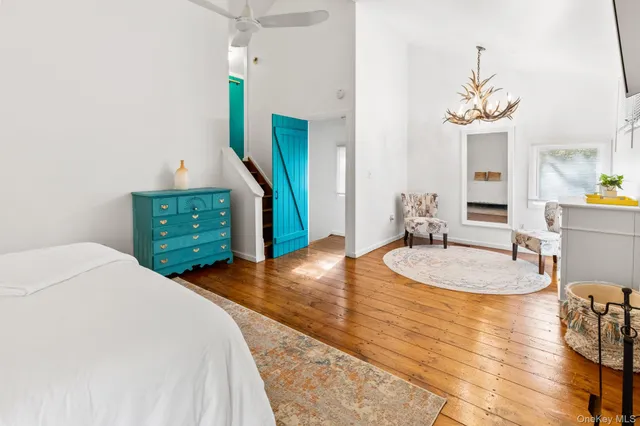 a bedroom with a bed and a chandelier