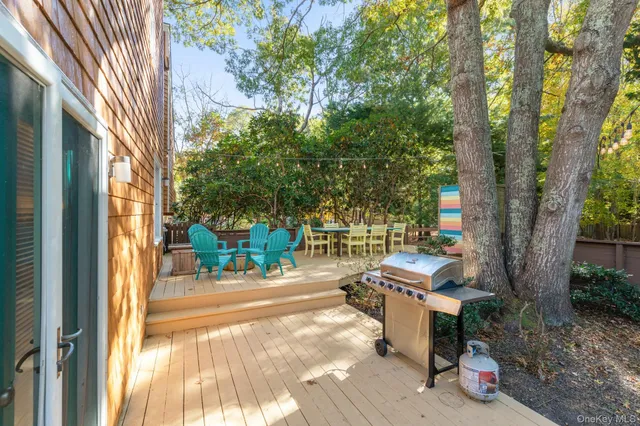 a backyard of a house with table and chairs