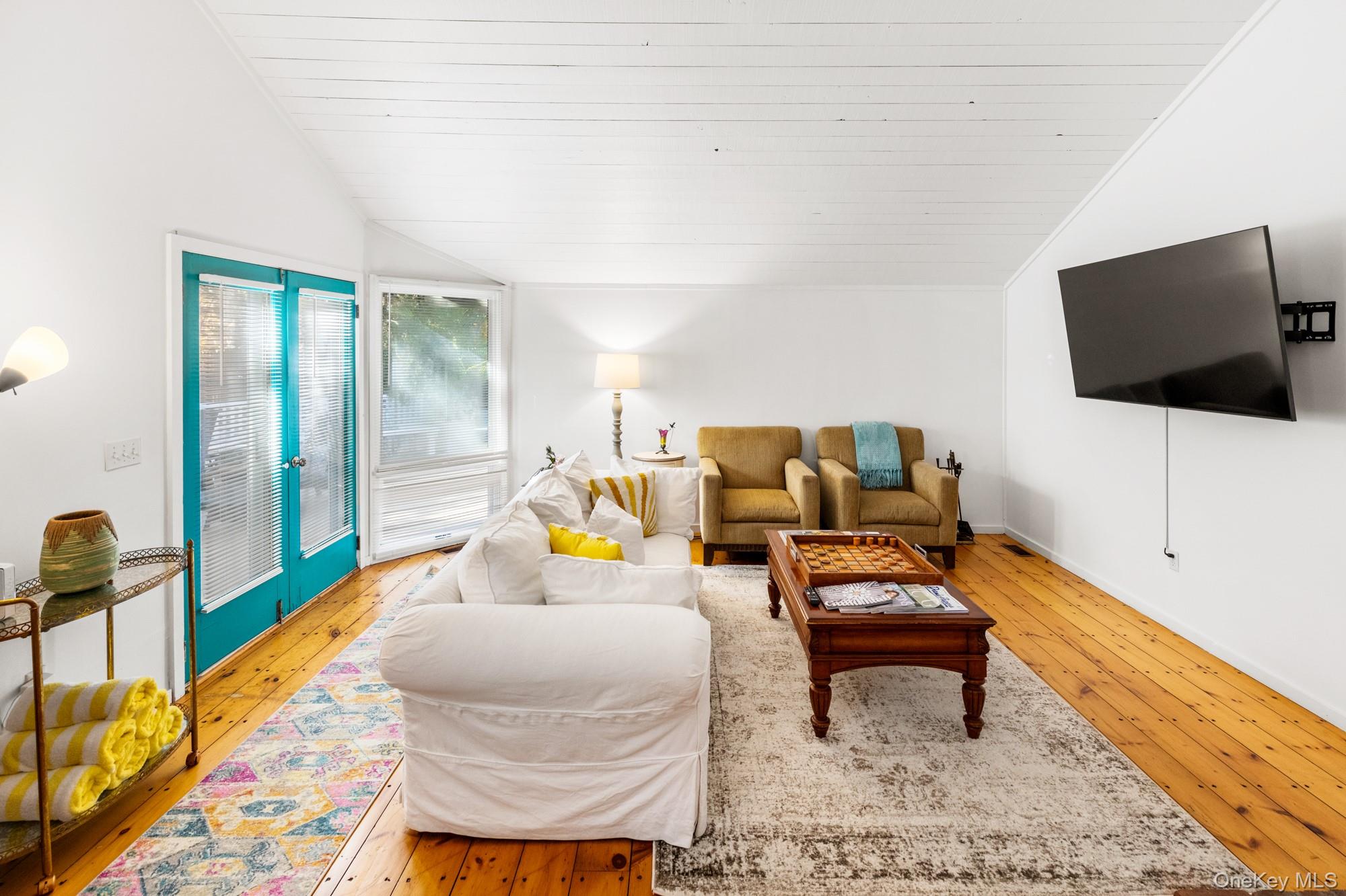 20 Norfolk Drive Springs, NY 11937 - Photo 4 of 23 a living room with furniture and a flat screen tv