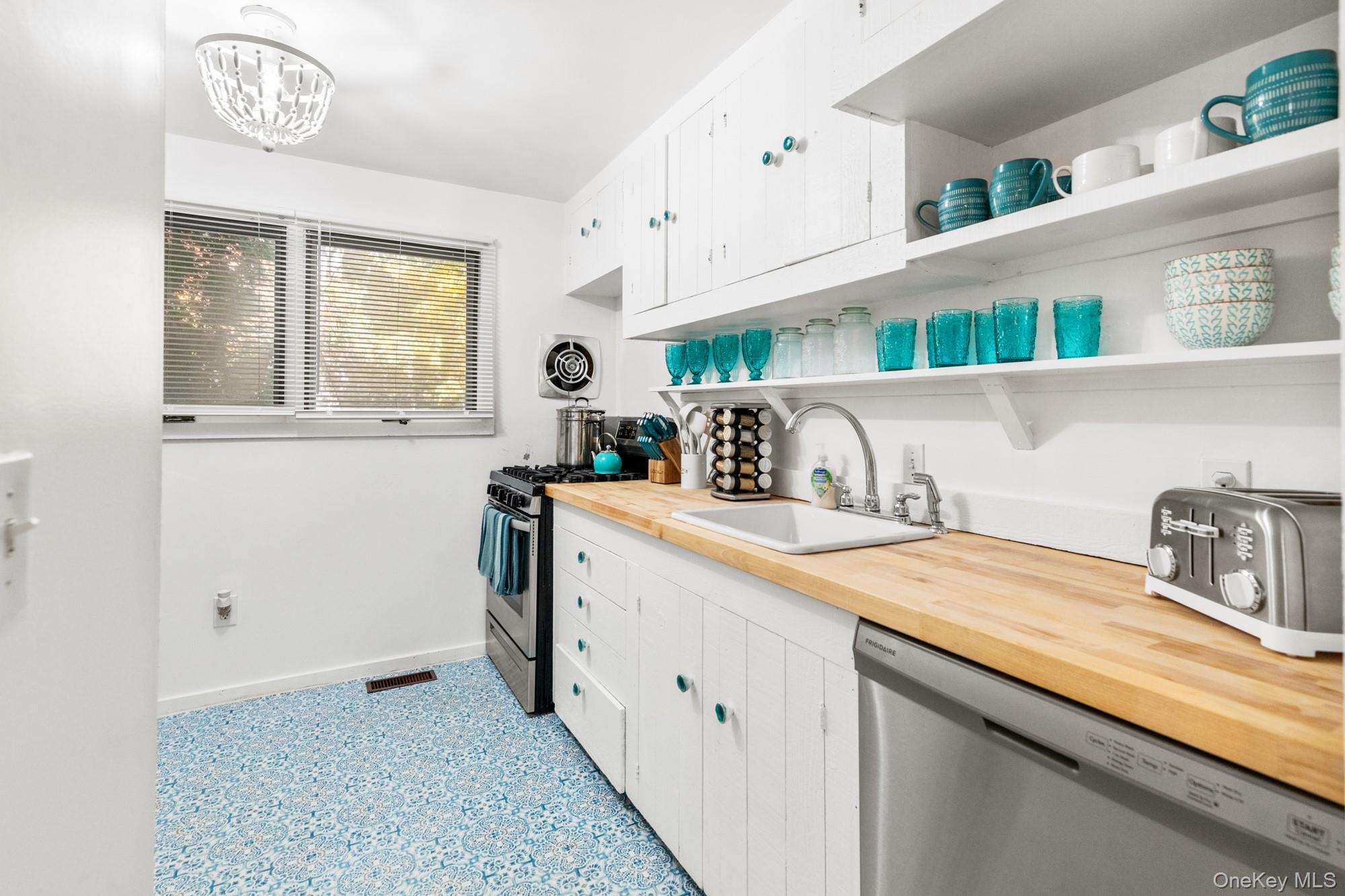 20 Norfolk Drive Springs, NY 11937 - Photo 6 of 23 a utility room with cabinets washer and dryer