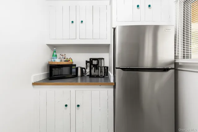 a kitchen with stainless steel appliances granite countertop a refrigerator and a cabinets