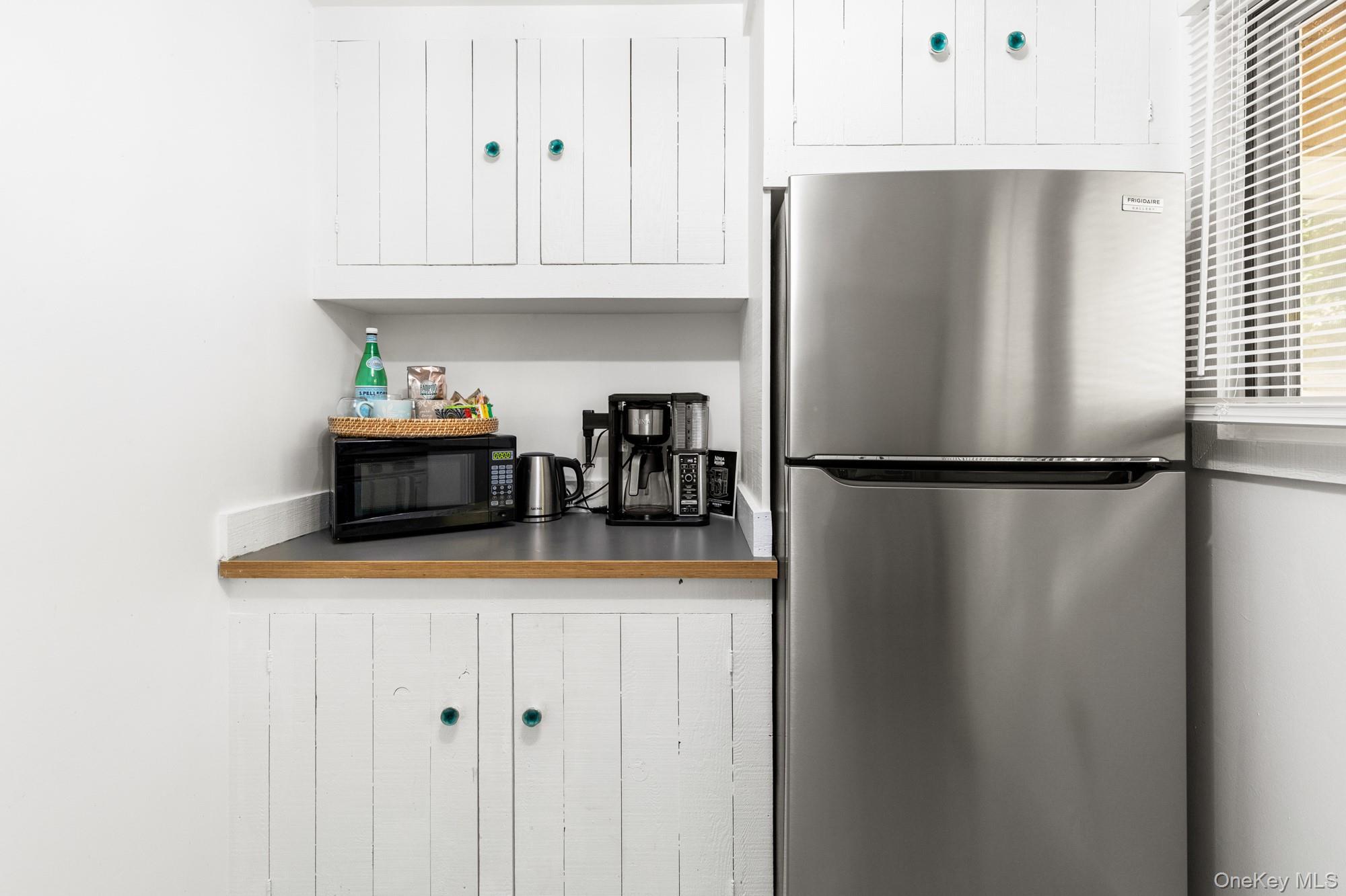 20 Norfolk Drive Springs, NY 11937 - Photo 7 of 23 a kitchen with stainless steel appliances granite countertop a refrigerator and a cabinets