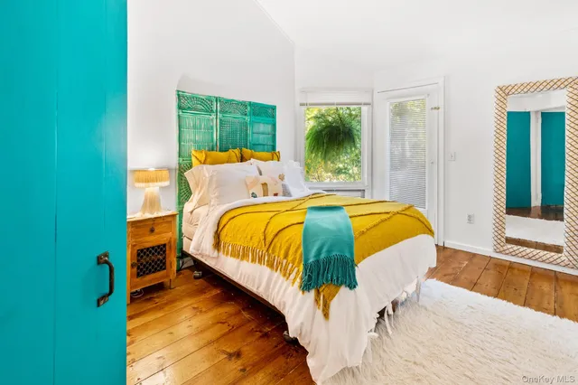 a bed sitting in a bedroom next to a window