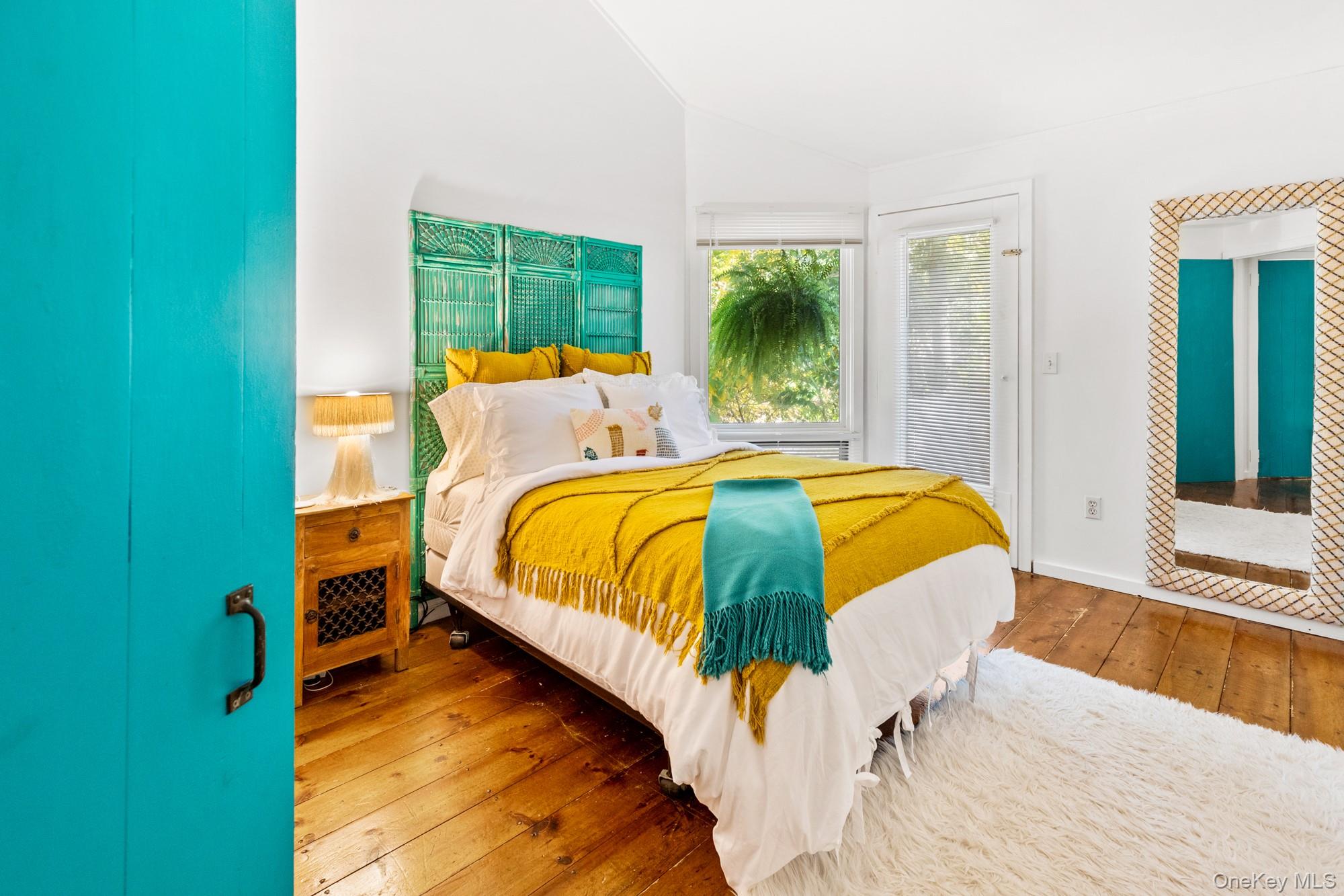 20 Norfolk Drive Springs, NY 11937 - Photo 8 of 23 a bed sitting in a bedroom next to a window