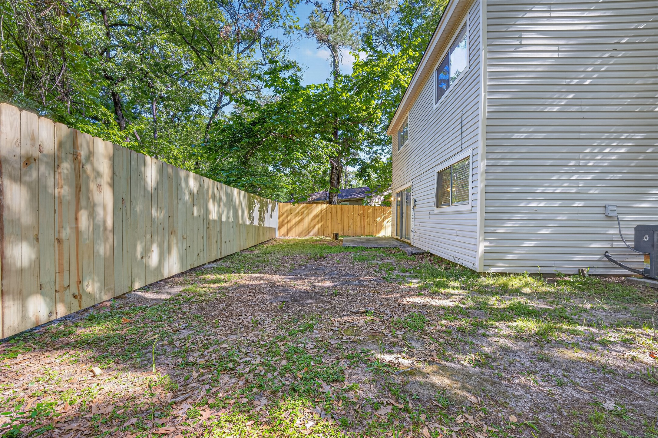 1106 East Red Cedar Circle Spring, TX 77380 - Photo 42 of 43 a backyard of a house with a yard and fence