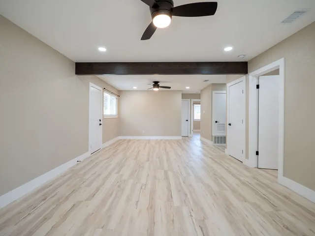 a view of empty room with wooden floor