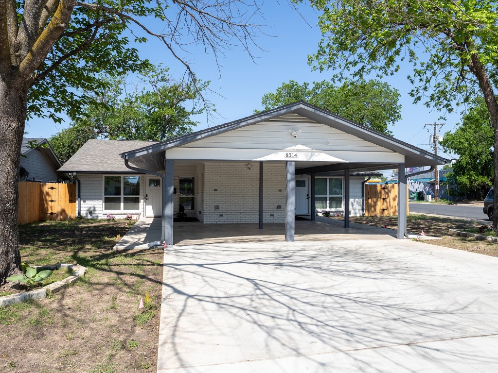 8314 Bowling Green Drive, Unit B Austin, TX 78757 - Photo 2 of 22 Single story home with brick siding, driveway, and an attached carport