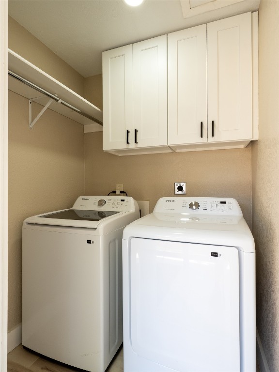 8314 Bowling Green Drive, Unit B Austin, TX 78757 - Photo 5 of 22 Laundry room with cabinet space and washer and dryer