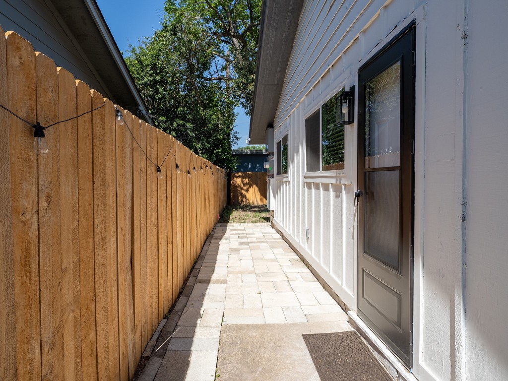 8314 Bowling Green Drive, Unit B Austin, TX 78757 - Photo 6 of 22 View of property exterior featuring a patio area and a fenced backyard