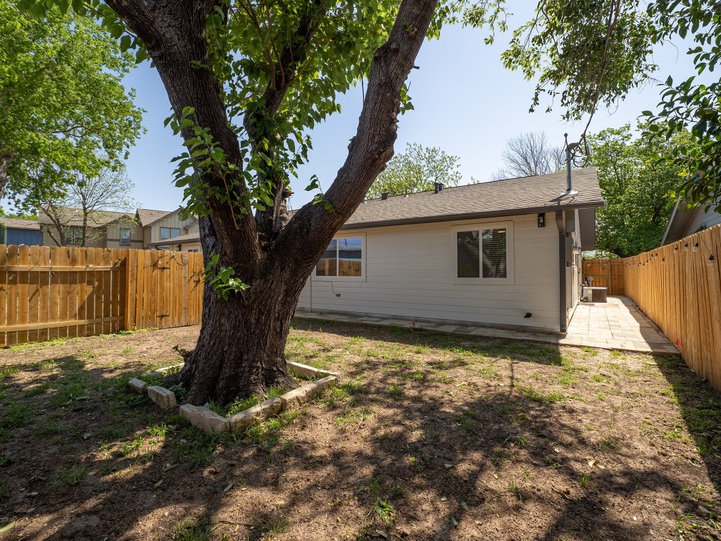 8314 Bowling Green Drive, Unit B Austin, TX 78757 - Photo 8 of 22 Rear view of house with a fenced backyard, a patio, and a shingled roof