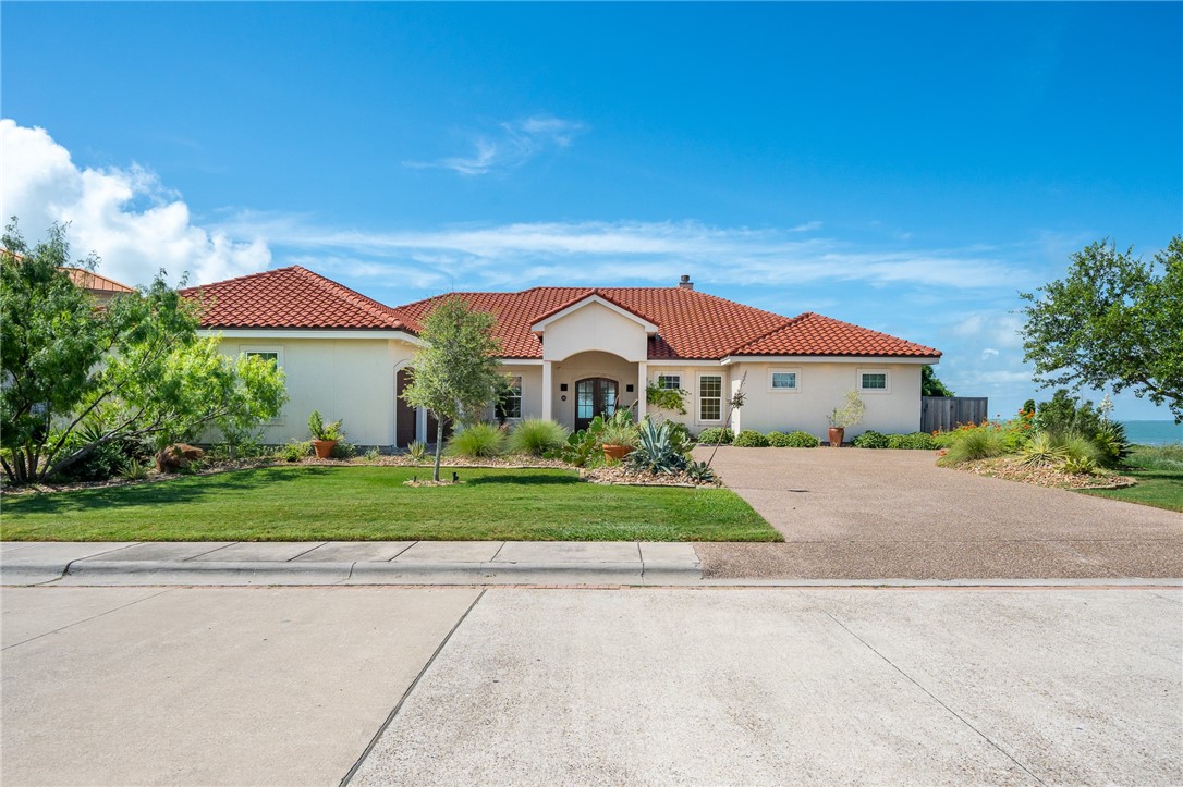 a front view of house with yard and green space