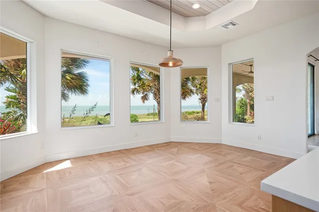 a spacious bedroom with a bed and glass windows